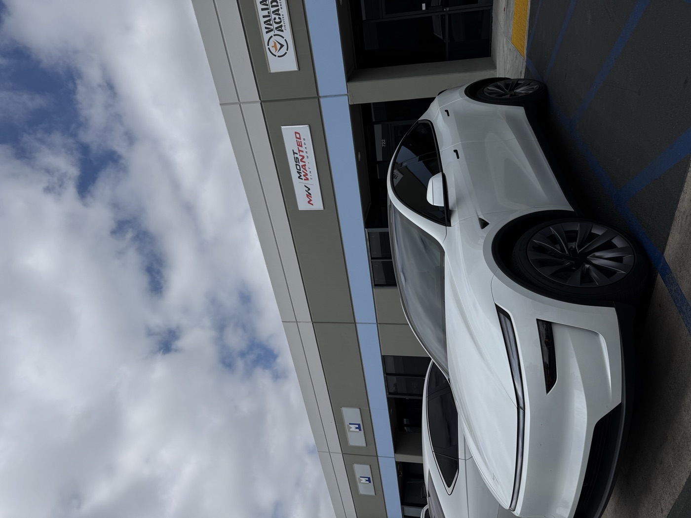 White Tesla Model Y with tinted windows at the shop